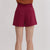 Garnet shorts worn by a person on a plain background