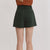 Person wearing green shorts on a plain background